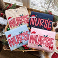 Embroidered Christmas Nurse Sweatshirt, Custom Ggingham Red Ribbon Santa Hat Nurse Shirt, RN Xmas Gift, Healthcare Worker Holiday Crewneck