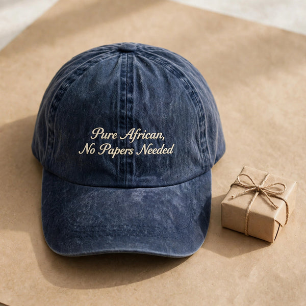 Washed navy cap with Pure African, No Papers Needed cream script embroidery, gift presentation